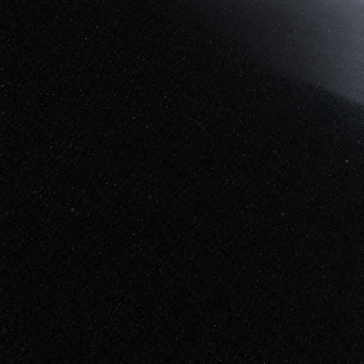 Close-up of a dark speckled stone surface