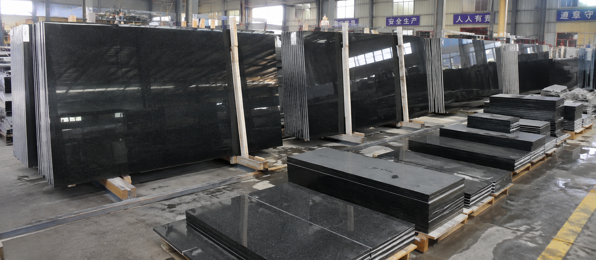 Dark stone slabs and rectangular pieces on timber supports indoors